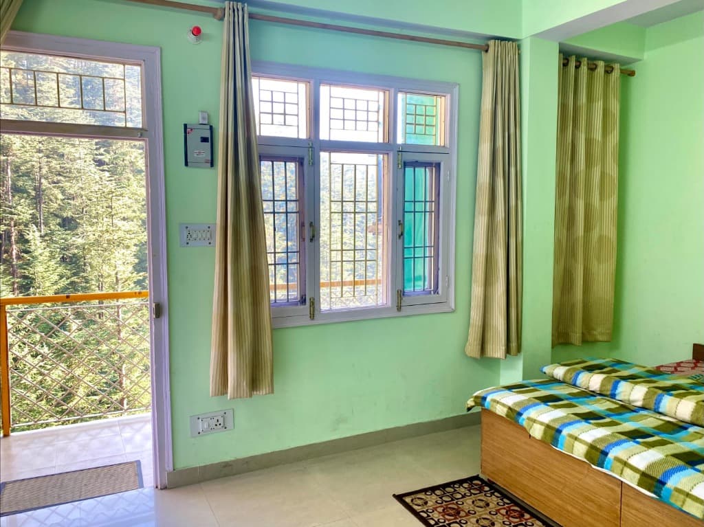Cedar View Deluxe Room interior and Himalayan view 2 at Dev Homestay Shimla